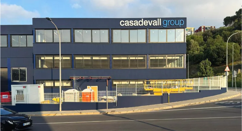 The Casadevall Group headquarters, a dark three-storey office and factory building.