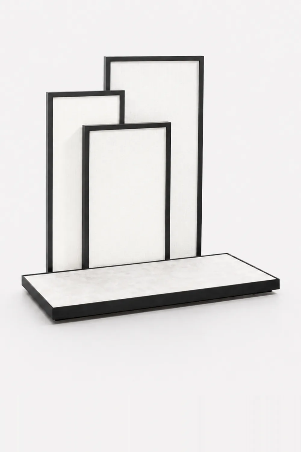 A set of display trays and backing panels in dark timber and stone, on white.